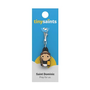 May include: A blue and yellow card with the text "tinysaint" and a cartoon image of Saint Dominic holding a book and a staff. The text "Saint Dominic Pray for us." is at the bottom of the card.