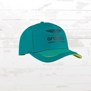 May include: Teal baseball cap with a curved brim and the Aramco Formula One Team logo. The cap features a green crown, a green brim with yellow trim, and a black logo. The cap is a sporty accessory.