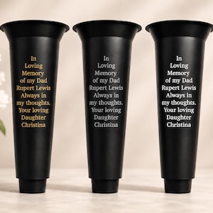 May include: Three matte black tapered memorial vases with flared rims. Each vase features the engraved text: In Loving Memory of my Dad, Rupert Lewis, Always in my thoughts, Your loving Daughter, Christina. The text appears in gold, silver, and white.