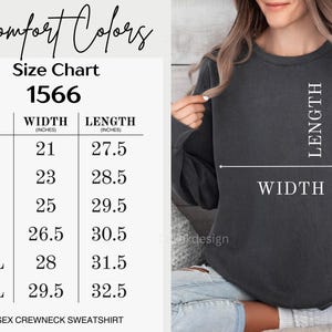 Pode incluir: Uma tabela de tamanhos para um moletom unissex com gola careca, com medidas em polegadas. A tabela inclui tamanhos de S a 3XL, com as dimens&otilde;es correspondentes de largura e comprimento. A imagem tamb&eacute;m mostra um moletom cinza escuro.