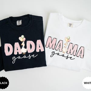 May include: A black long-sleeve sweatshirt and a white long-sleeve sweatshirt. The black sweatshirt features the text DADA goose with a goose holding balloons. The white sweatshirt features the text MAMA goose with a goose holding balloons.