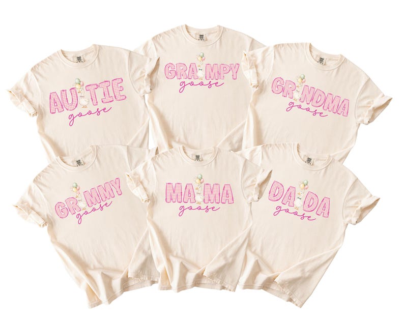 May include: Six cream-colored short-sleeve t-shirts featuring pink plaid lettering and a goose graphic. The shirts display the text: AUTIE goose, GRAMPY goose, GRNDMA goose, GRMMY goose, MA MA goose, and DA DA goose in a consistent font style.