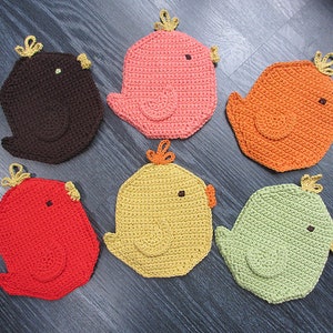 May include: Six crocheted bird-shaped pot holders in various colors, including brown, pink, orange, yellow, red, and green. Each pot holder has a small yellow flower on top.