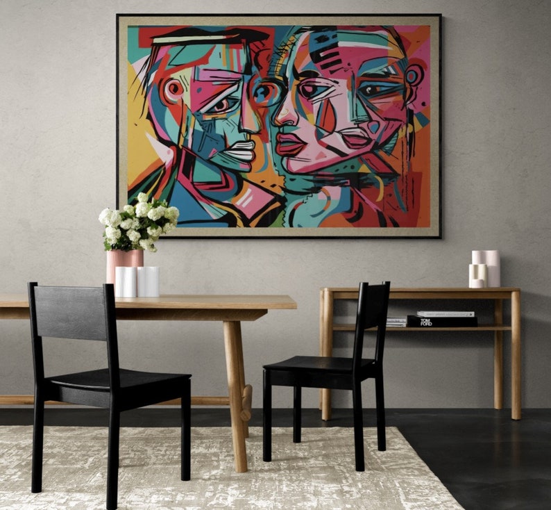 Puede incluir: Pintura abstracta de dos caras, una masculina y una femenina, con colores vivos y formas geom&eacute;tricas. La pintura est&aacute; enmarcada en negro y colgada en una pared gris.