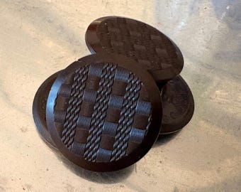 Four antique Goodyear 1851 hard rubber buttons, large weave patterns.