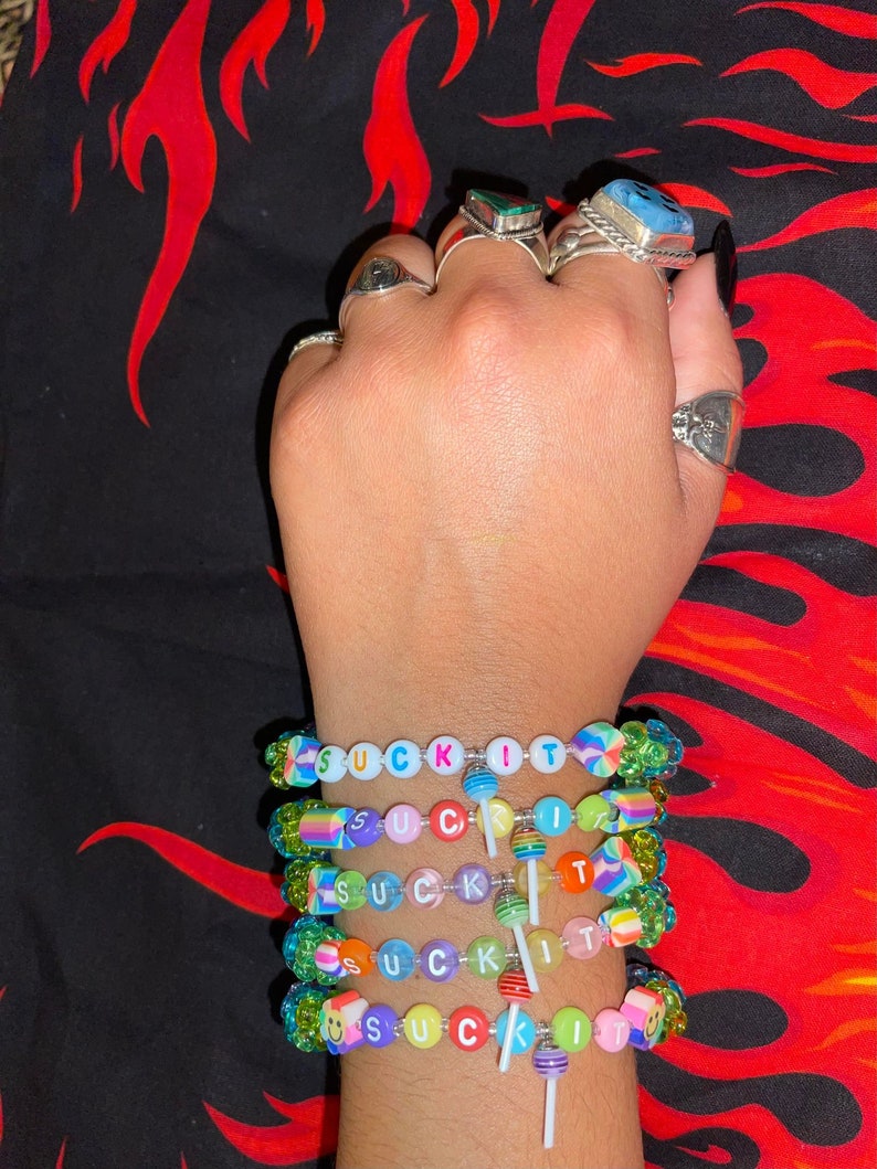 "suck it" Kandi bracelets with rainbow tri beads and sucker charms