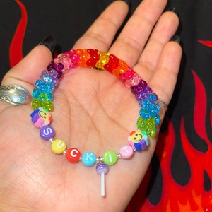 "suck it" kandi rainbow bracelet with tribeads and purple sucker charm