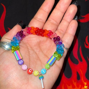 "suck it" rainbow kandi bracelet with tribeads and rainbow sucker charm