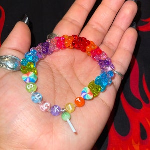 "suck it" kandi bracelet with rainbow tribeads with tribeads and green sucker charm