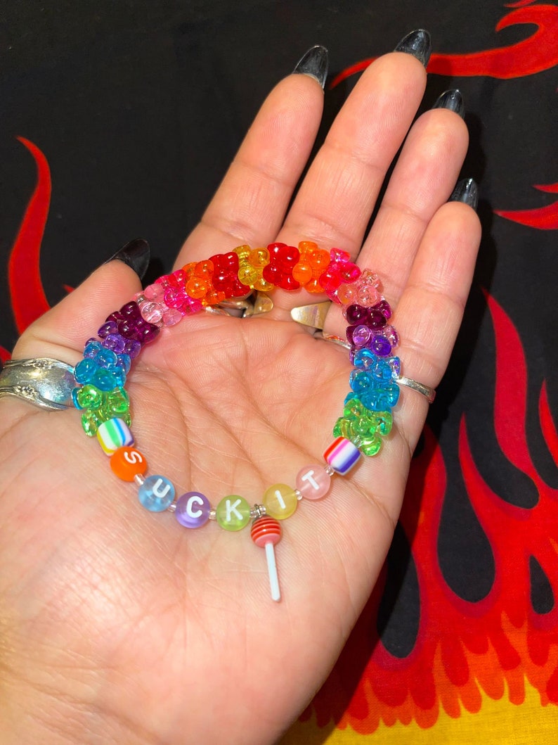 "suck it" rainbow kandi bracelet with tribeads and red sucker charm