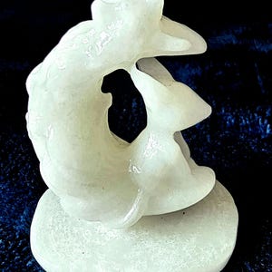 White Jade nine tailed fox with crescent moon, flowers and a crown. Kitsune sculpture.