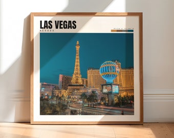 May include: A framed print of a nighttime cityscape of Las Vegas, Nevada. The Eiffel Tower replica is illuminated with golden lights, and a hot air balloon with blue and white lights is in the foreground. The print has the text "LAS VEGAS" and "NEVADA" in black text.