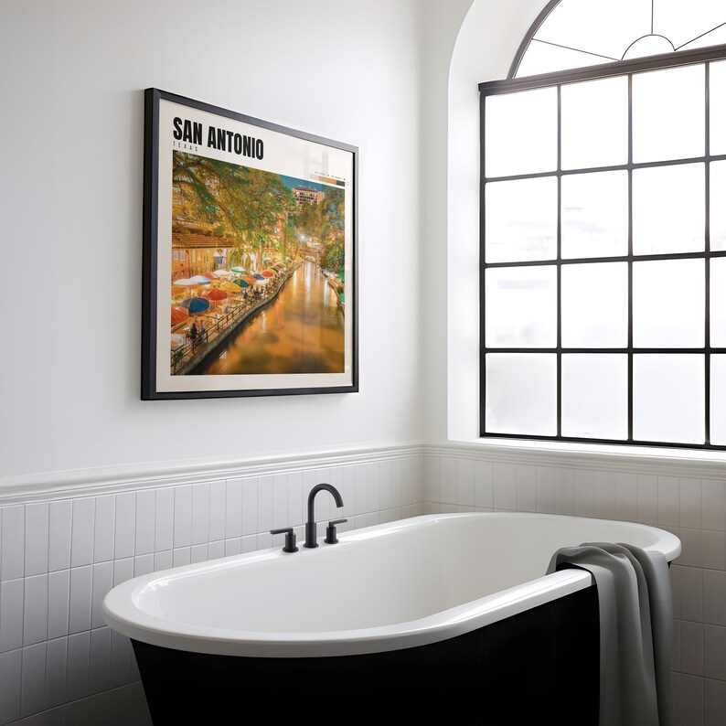 a bathroom with a bathtub and a picture on the wall