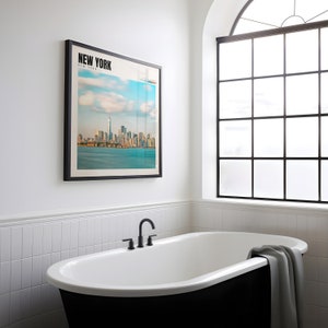 a bathtub in a bathroom with a picture on the wall
