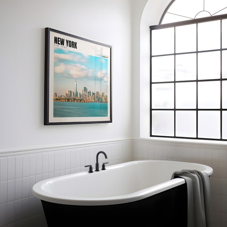 a bathtub in a bathroom with a picture on the wall