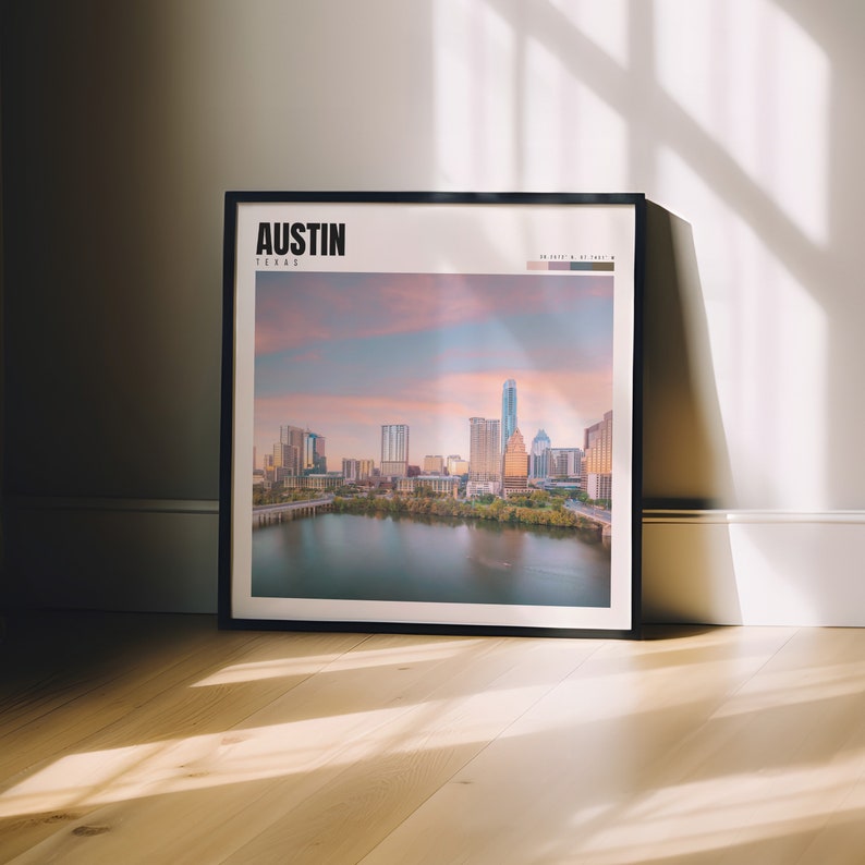 a picture frame sitting on a wooden floor in front of a window