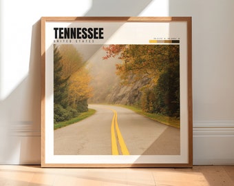 May include: A framed print with a photograph of a winding road through a foggy forest in the fall. The text "TENNESSEE" and "UNITED STATES" is at the top of the print.