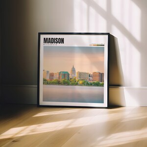 a picture frame sitting on a wooden floor in front of a window