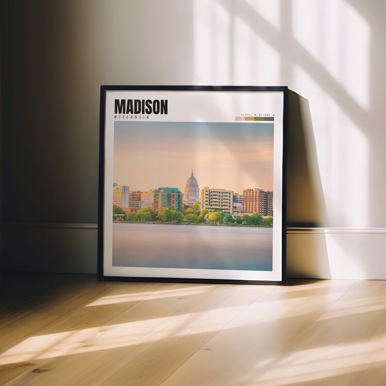a picture frame sitting on a wooden floor in front of a window