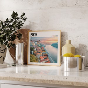a picture of a city on a wall next to a potted plant