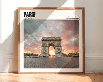 May include: A framed photograph of the Arc de Triomphe in Paris, France, with a sunset sky in the background. The text "PARIS FRANCE" is printed in black at the top of the image.