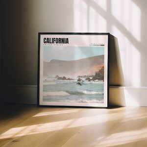a picture frame sitting on a wooden floor in front of a window