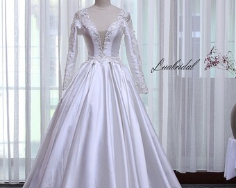 Noble princess wedding dress. wedding dress with deep V neckline. Long sleeve design with delicate lace trim.