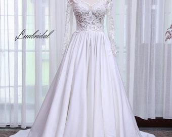 Luxus-Hochzeitskleid. Prinzessinnen-Brautkleid in A-Linie. Edles Langarm-Brautkleid aus Satin.