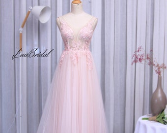 A-line wedding dress with deep v neckline. The pink color is sewn and attached with lace and artificial pearls and sparkling stones.