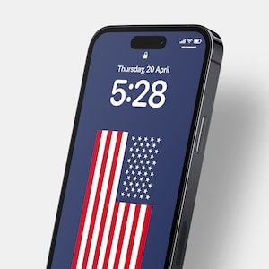 May include: A black smartphone with a blue screen displaying the time 5:28 and the date Thursday, 20 April. The screen also shows an American flag.