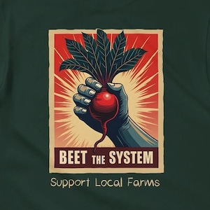 May include: A green t-shirt with a graphic of a beet being held up in a fist. The graphic is in a vintage style with red, yellow, and white colors. The text "BEET THE SYSTEM" is below the graphic, and the text "Support Local Farms" is below that.