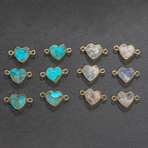 May include: Twelve heart-shaped gemstone connectors with gold-toned metal accents. Six connectors feature turquoise gemstones and six feature moonstone gemstones.