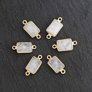 May include: Six gold-toned connectors with white moonstone rectangular stones. Each connector has two loops for attaching to jewelry.