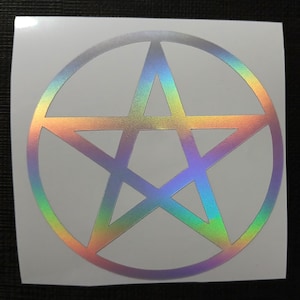 May include: A white sticker with a holographic pentagram design. The pentagram is a five-pointed star with a circle around it. The holographic effect creates a rainbow of colors.