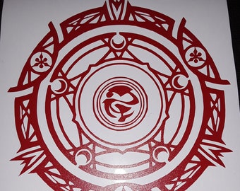 May include: A red circular design with intricate details and a stylized symbol in the center. The design is reminiscent of a crest or emblem.