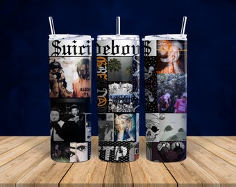 May include: Three stainless steel tumblers featuring black and white images of a band called "Suicideboys". The tumblers have black lids and straws.