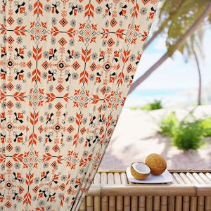 May include: Cream-colored curtain with a repeating pattern of orange, black, and gray geometric shapes. The curtain is partially drawn, revealing a tropical beach scene with palm trees and the ocean. Two coconuts sit on a white plate.