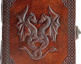 May include: A brown leather journal with a Celtic knot border and a detailed embossed image of two dragons intertwined.