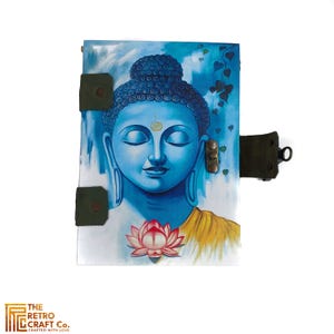 May include: A blue leather journal with a painting of Buddha on the front cover. The journal has a green leather strap and a metal clasp.