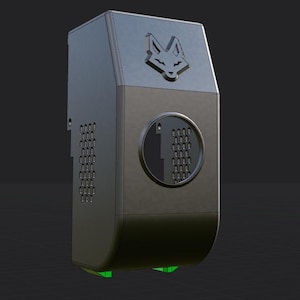 May include: A dark gray rectangular device with a fox head logo on top. The device has a circular dial with a number 1 and a grid of small holes. A series of holes are on the left side. Green accents are visible at the bottom.