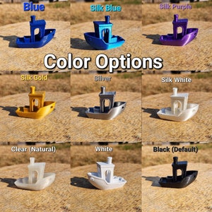 May include: Color options for a small 3D printed boat model. The boat is available in blue, silk blue, silk purple, silk gold, silver, silk white, clear, white, and black.