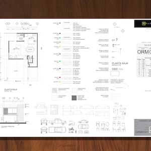 May include: A black and white architectural blueprint with a floor plan labelled "Planta Baja" and a table of "Cód. Item" and "Denominaciones". The blueprint includes a key with symbols and colours for different building materials and features. The blueprint is labelled "ORM0101" and "CRAMAG arquitectos".