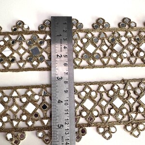 Decorative gold mirror ribbon trim with floral scalloped edges, suitable for dancewear, stage costumes, and handmade fashion accents.