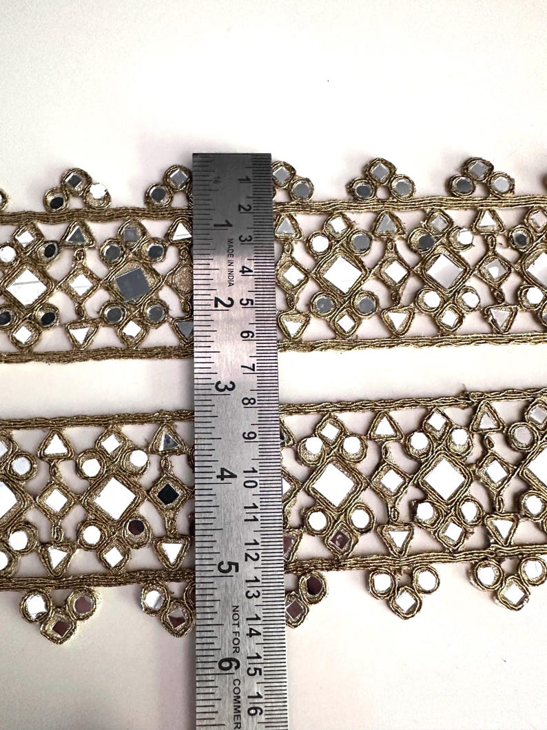 Decorative gold mirror ribbon trim with floral scalloped edges, suitable for dancewear, stage costumes, and handmade fashion accents.