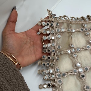 Close up of real mirror hand embroidery with scalloped mirror border on luxury net dupatta