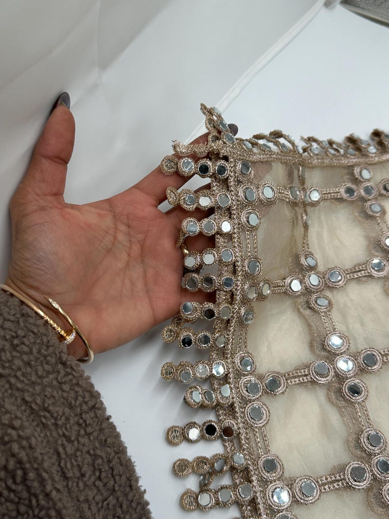 Close up of real mirror hand embroidery with scalloped mirror border on luxury net dupatta
