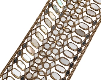 May include: Gold trim lace with a geometric pattern of oval-shaped mirrors. The mirrors are surrounded by a gold metal frame and have a reflective surface.