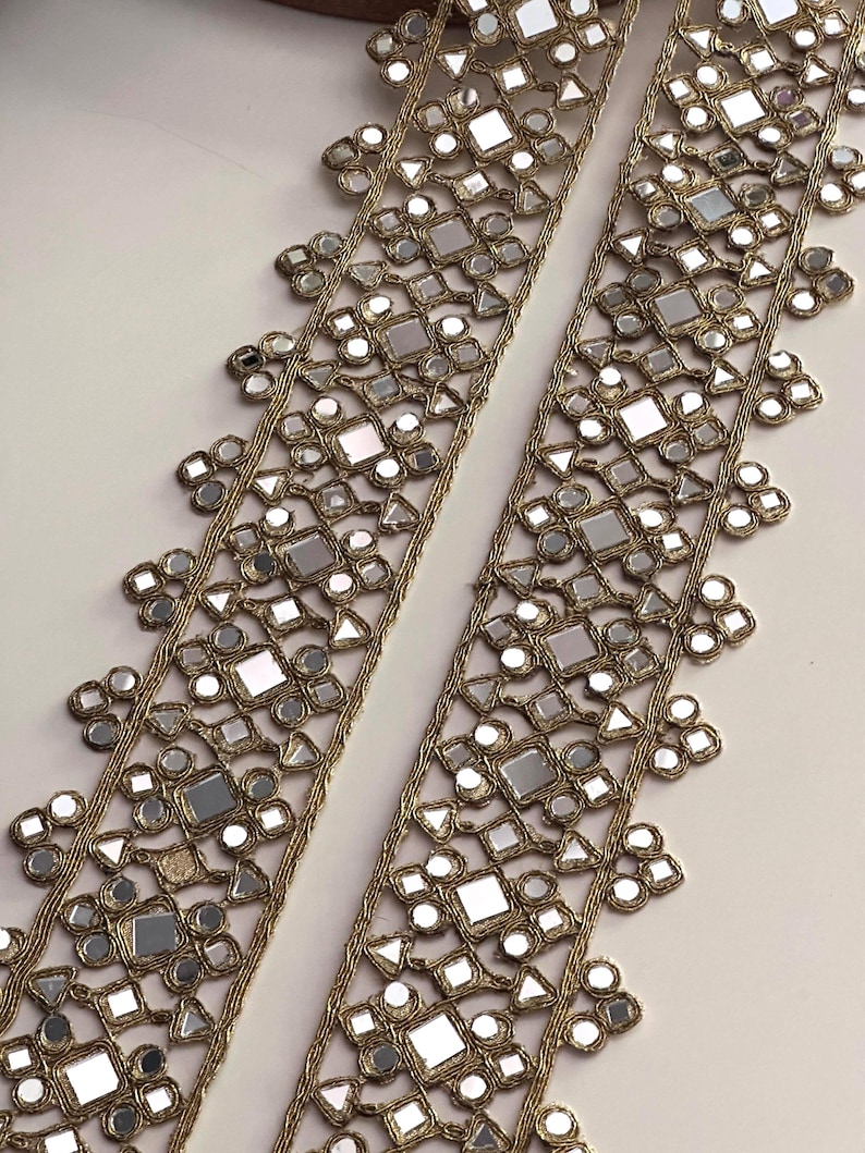 Reflective mirror belt lace trim laid out on a white surface, ideal for making boho-chic cinturon belts and wedding crafts.