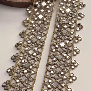 Golden sequin and mirror work border lace used for making bridal sashes, lehenga belts, and decorative costume accessories.