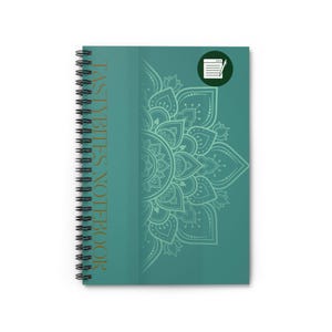 May include: Teal blue spiral notebook with a gold inscription that reads "Tasty Bites Notebook". The cover features a white mandala design with a green outline.
